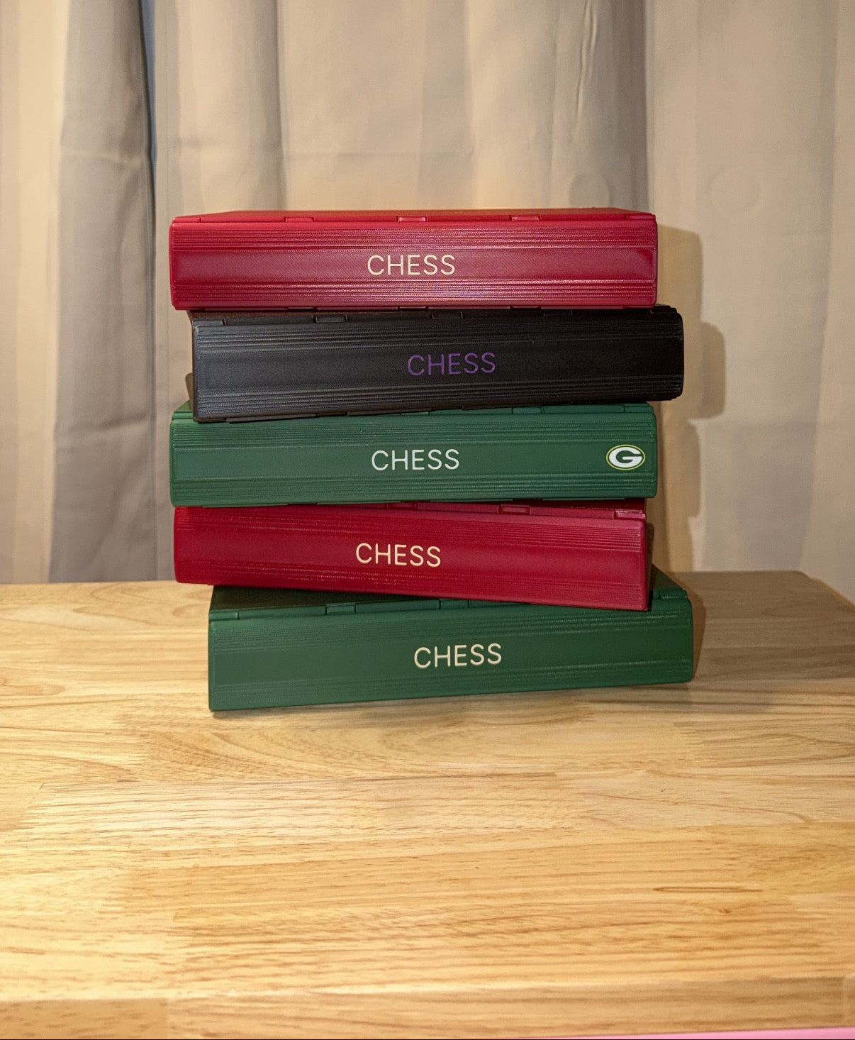 5 chess books stacked on top of one another